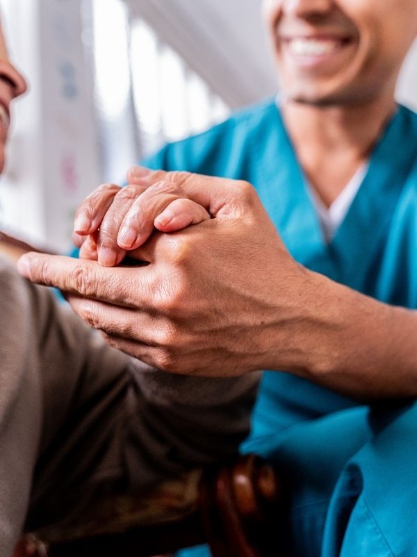 caregiver and elderly hands