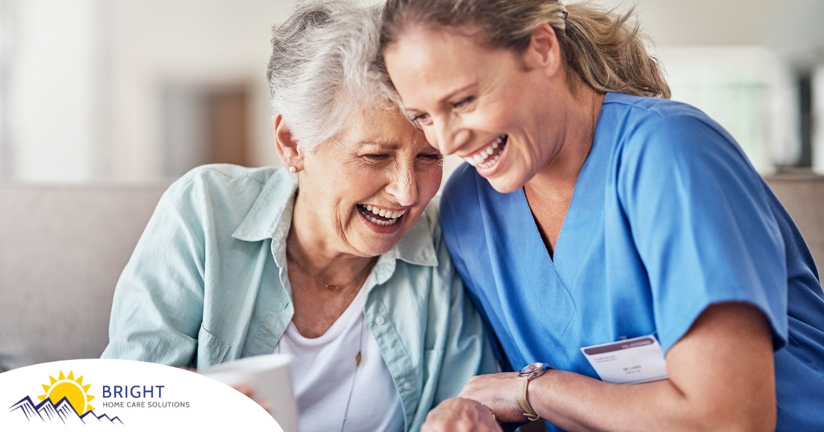 A woman in scrubs laughs with a senior woman, representing how caregiving can be a great career choice.