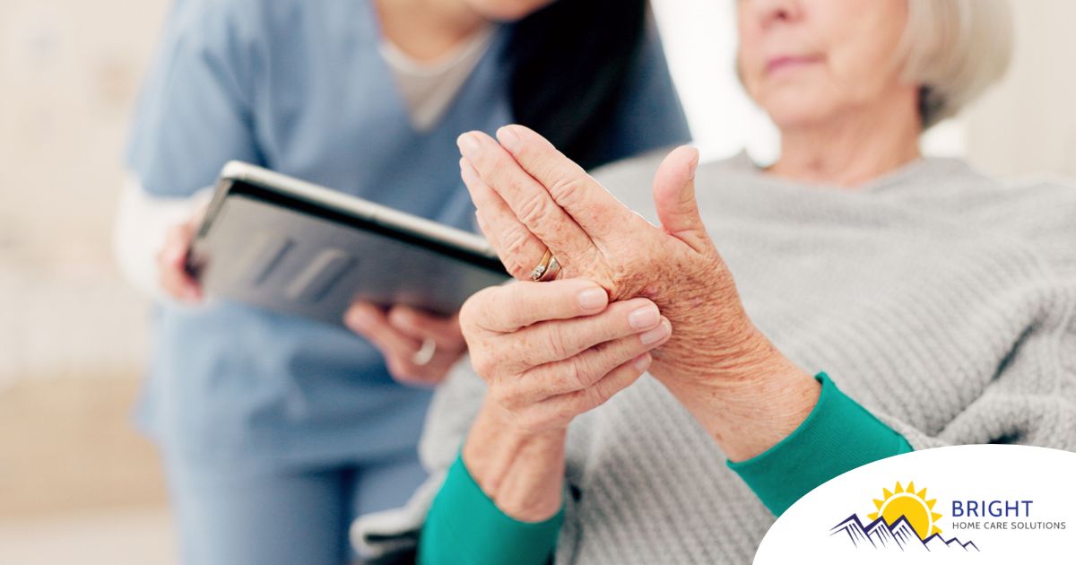 A caregiver provides in home care services to a senior with arthritis